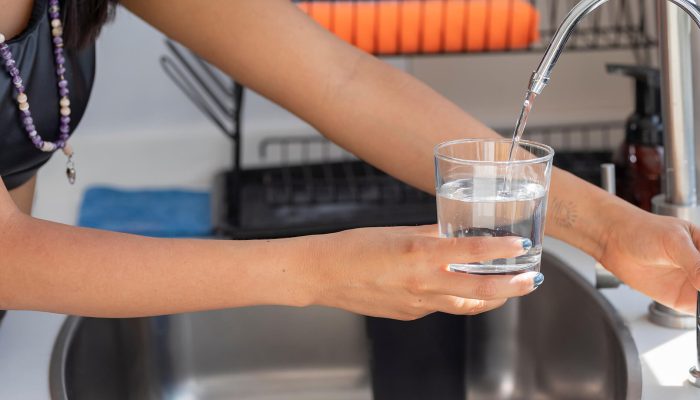 Pouring a glass of water from a tap