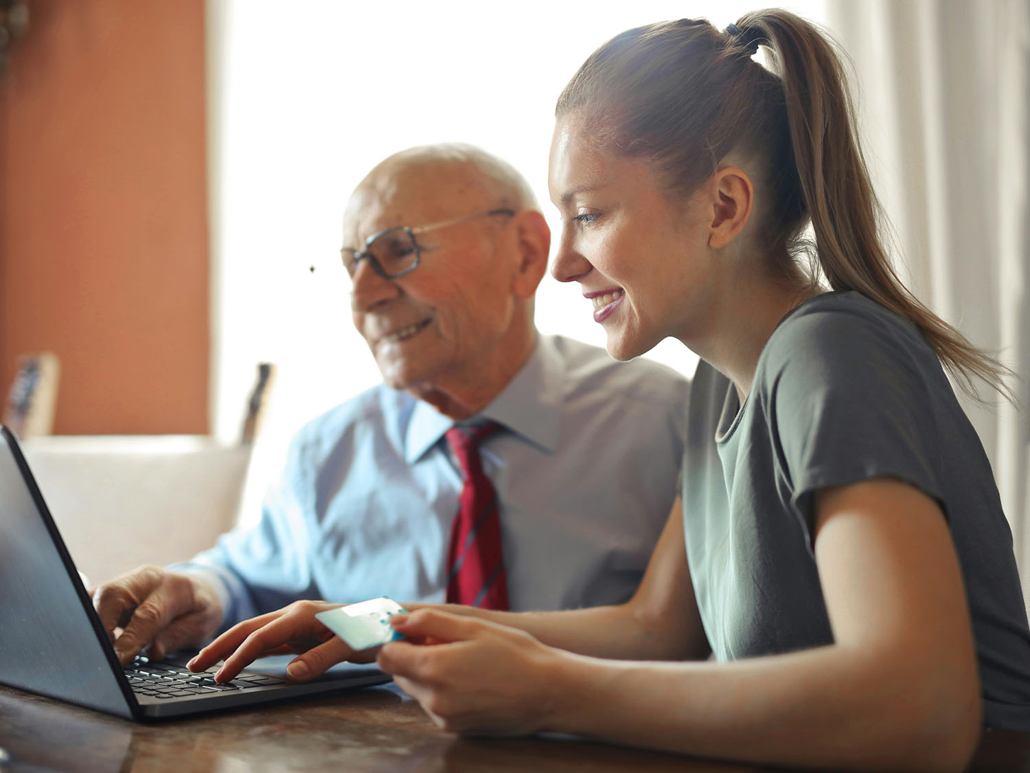A young woman and and older man sitting at a computer