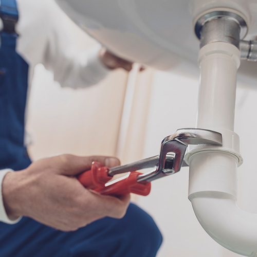 A person repairing a sink