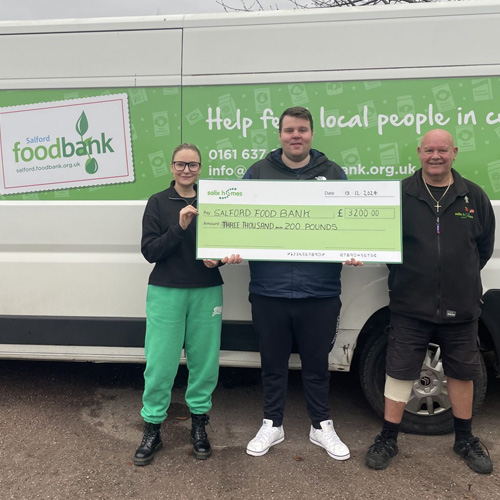 Salix Homes staff with a cheque for Salford Food Bank