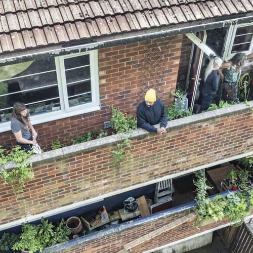 People gardening on a balcony