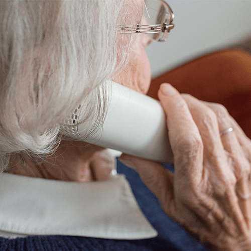 A lady using a telephone