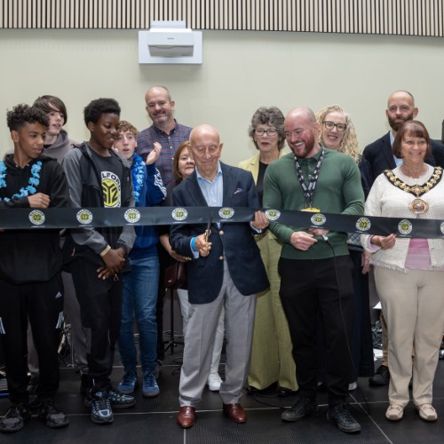 A group of people cut the ribbon at the launch of Salford Youth Zone