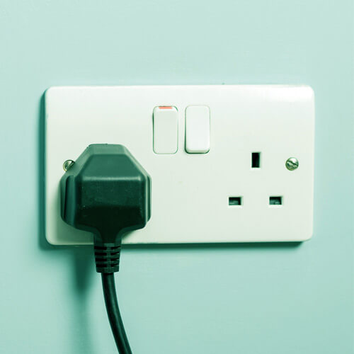 An electrical plug plugged into a wall socket