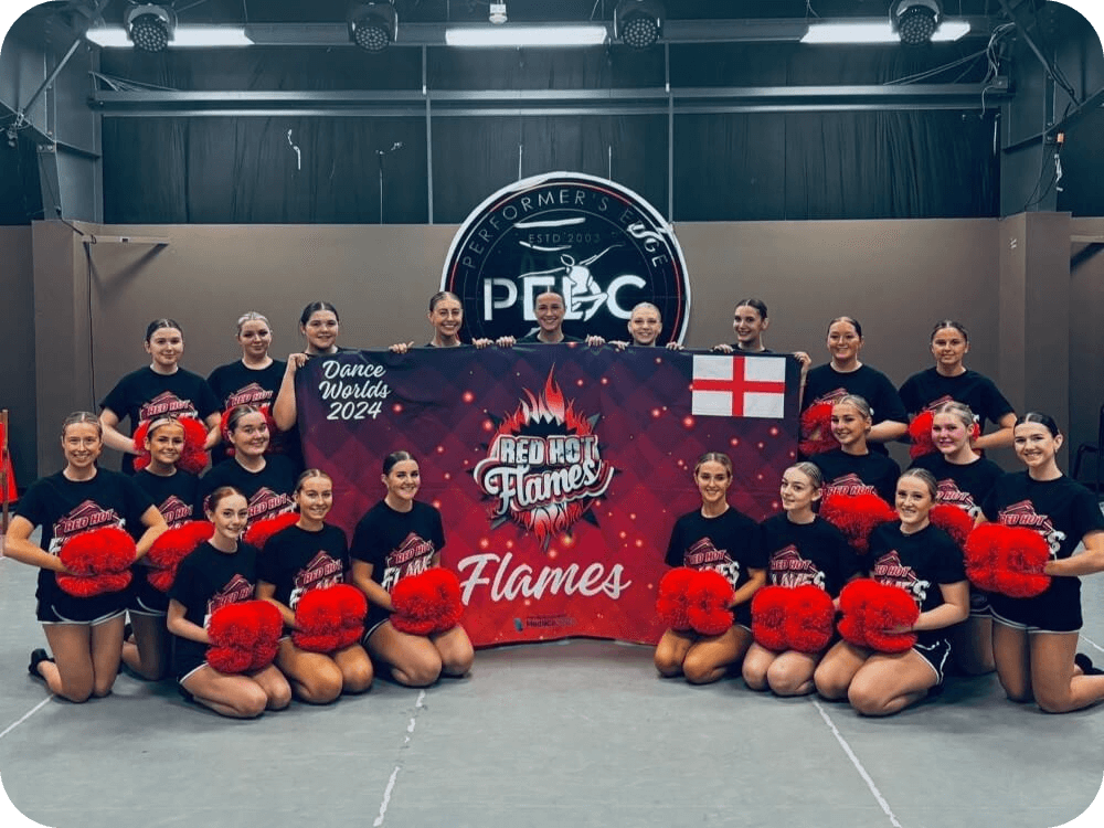 A group of young cheerleaders holding a Red Hot Flames banner