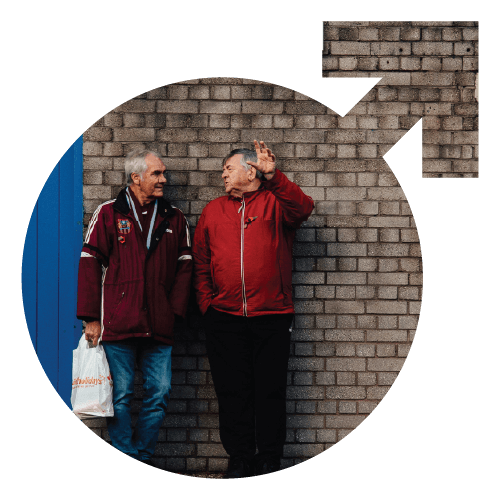 Two men stood talking outside a football ground