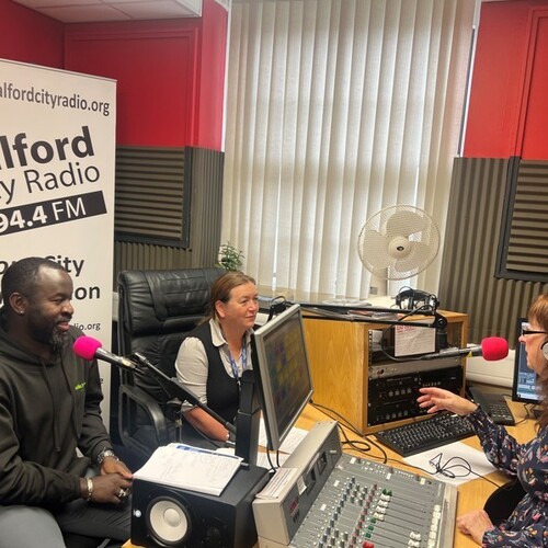 Two members of Salix Homes staff talking about Manbassadors in the Salford City Radio studio