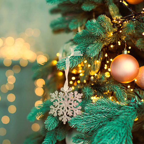 A close-up of decorations hanging on a Christmas tree