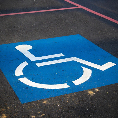 A parking space marked with a blue disabled badge