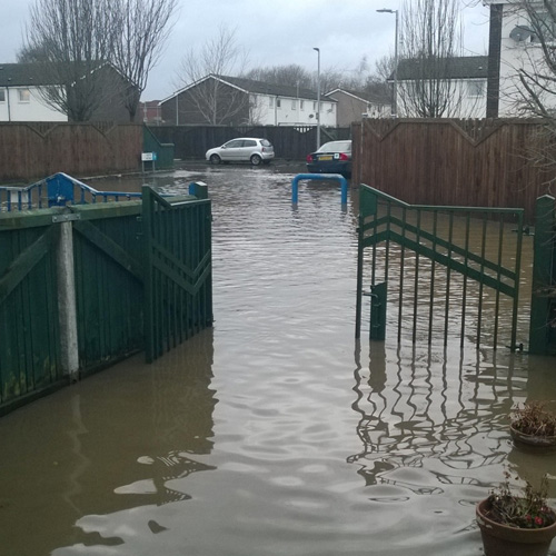 A flooded front garden and road